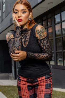 Camisa con croptop en blonda grabada y cuello alto, aberturas en hombros y manga larga y camisa tipo esqueleto en algodón lycrado negro./ Shirt with a croptop in engraved lace and high neck, shoulder and long sleeve openings, and skeleton-style shirt in black lycra cotton.
